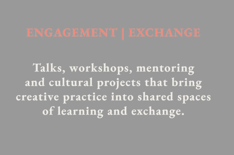 Explore Engagement and Exchange: participants examine photographic materials around a table, introducing talks, workshops, mentoring and cultural projects.