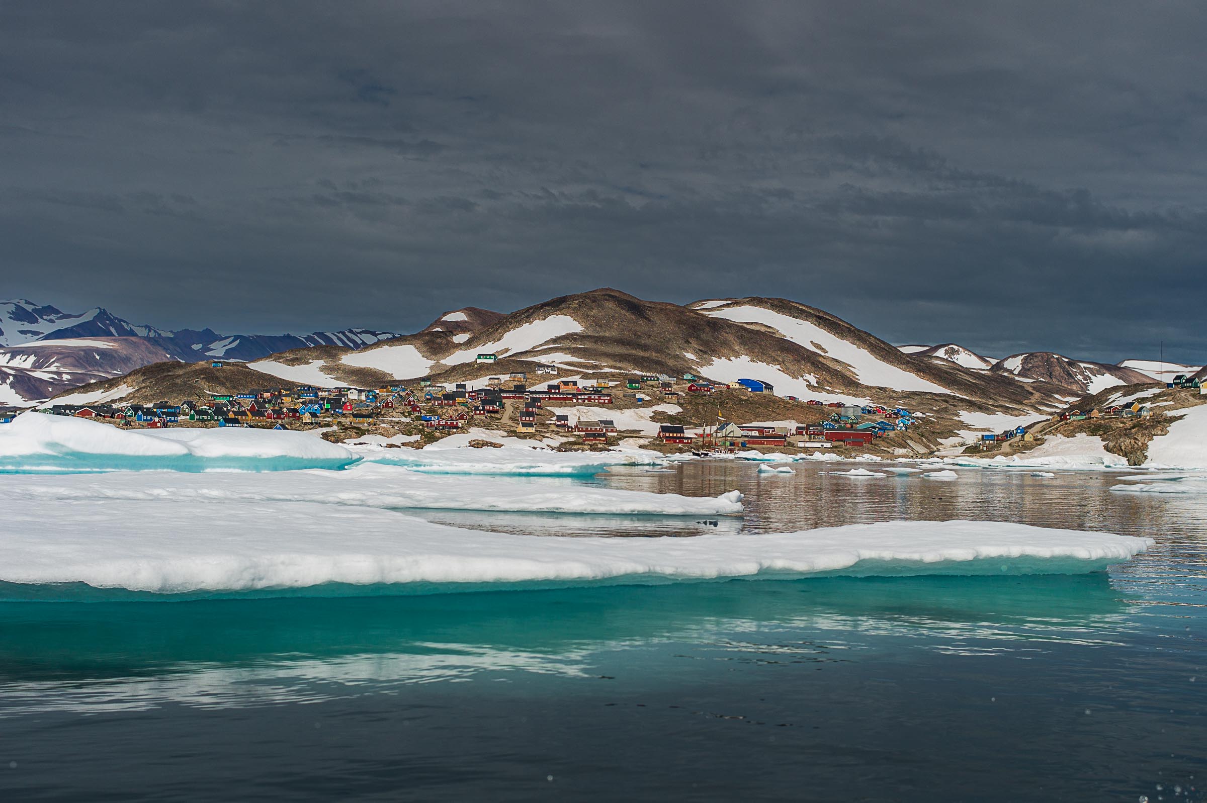 Ittoqqortoormiit, one of Greenland’s most remote towns, seen beyond sea ice near the entrance to Scoresby Sund in northeast Greenland.