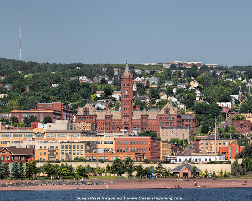 Duluth’s Old Central High School was built in 1892 of locally mined sandstone. Overlooking the Duluth harbor, it dominates the cityscape towering over the city’s business district. At $460,000, it was one of the most costly public works projects of the era. It was designed by local Duluth architects who borrowed from some of the best in eclectic Richardsonian Romanesque design to give the city a school to rival even the master, Henry Richardson’s own work. It features a 230 foot clock tower that was patterned after Big Ben in London. They didn’t miss a detail, from smiling cherubs and grotesque animal figures over the cavernous entrance to the towering clock tower. It’s simply amazing! In 1972, it ceased to be the Central High School but it is still in use by the school district.