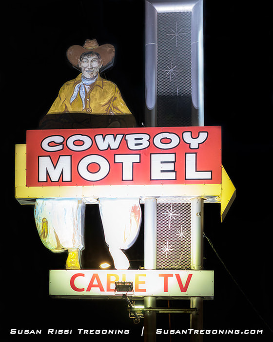 A large 1963 cowboy‑shaped motel sign at the Cowboy Motel in Amarillo, Texas, with its former neon tubing removed and bulb holes filled, standing as a vintage roadside landmark along Route 66.