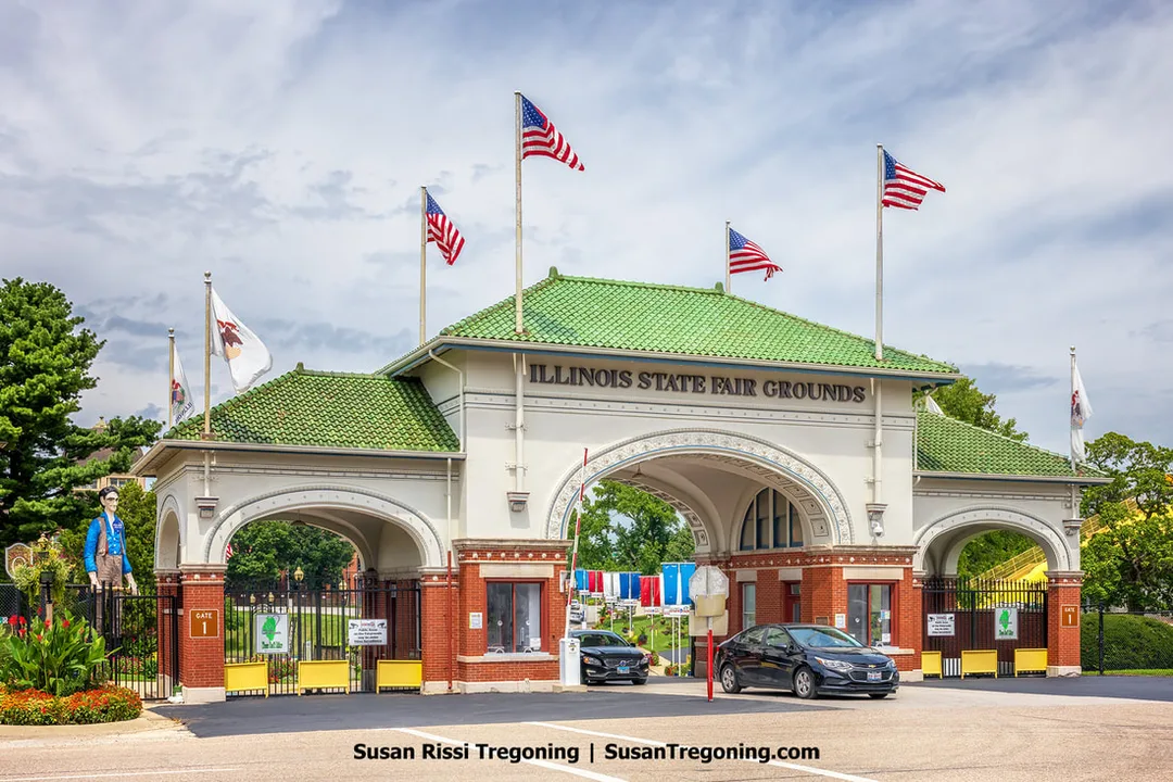 The historic 1910 main gate at the Illinois State Fairgrounds in Springfield, Illinois, stands along Route 66. Behind the gate is the Abe Lincoln Rail Splitter statue, positioned within the fairgrounds. The Illinois State Fairgrounds are the only fairgrounds located on Route 66.