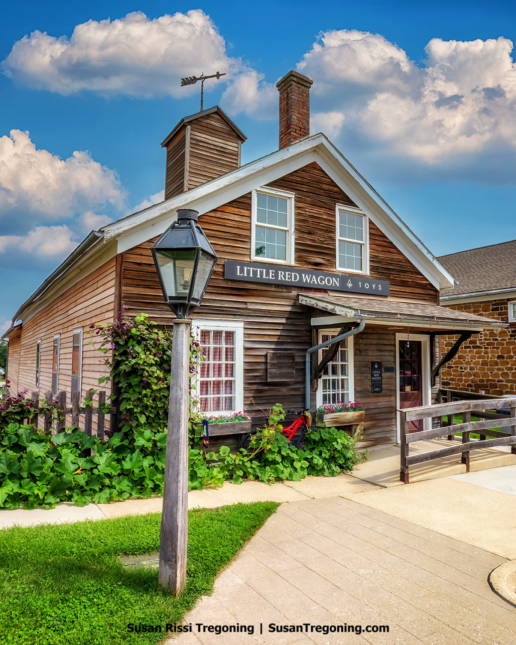 The charming Little Red Wagon toy store in Iowa’s Amana Colonies occupies a historic structure with a rich and varied past. Initially constructed in 1860 as a watch house, this building has served many roles over the years.