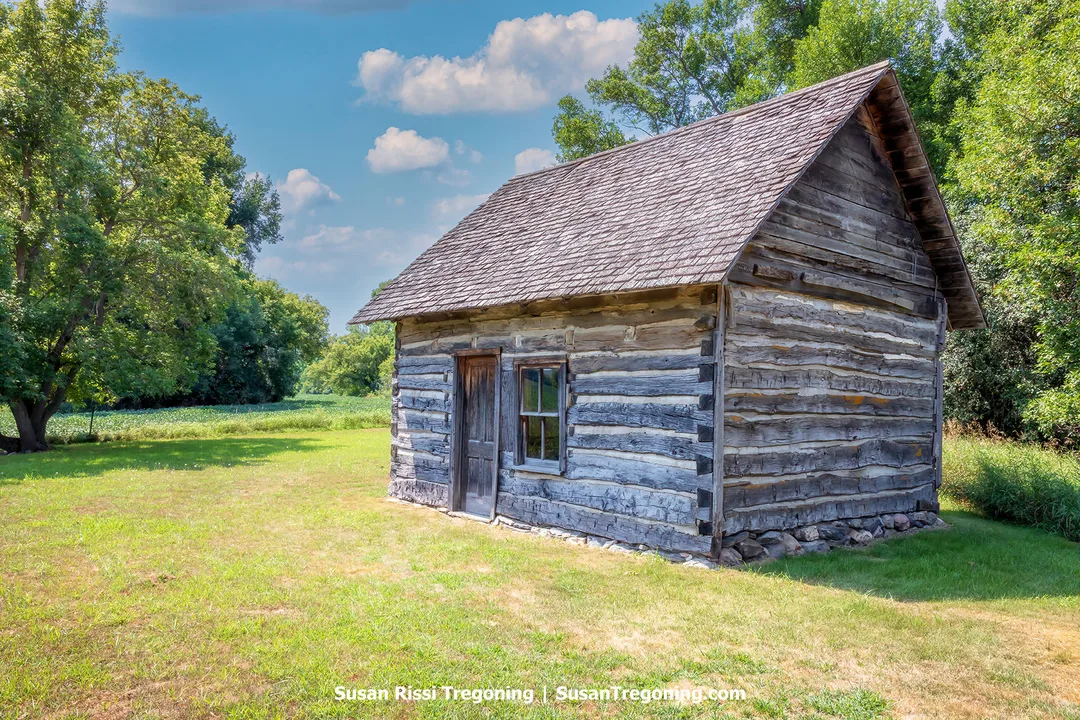 The Wadeson Cabin at Wadeson Park State Historic Site near Kathryn, North Dakota. It’s a small, hand‑hewn log structure built in 1876 by Norwegian settlers Carl Jenson and Jon Bjerke. The cabin rests on a simple stone foundation, with dovetailed oak logs and a steep shingled roof — a classic example of early frontier craftsmanship. Surrounded by open grass and mature trees along the Sheyenne River, it reflects the quiet resilience of North Dakota’s first homesteaders.