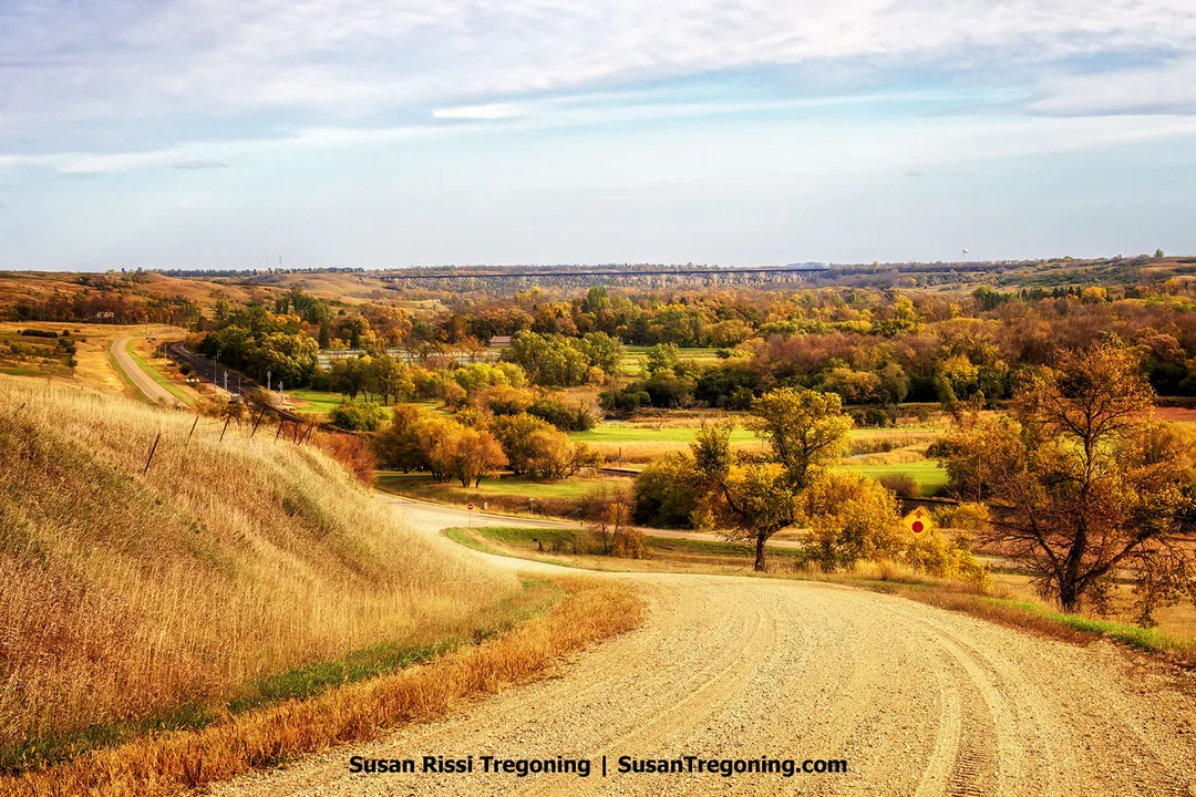 The Hi-Line Railroad Bridge spans the Sheyenne River Valley above autumn-colored trees and rolling grasslands near Valley City, North Dakota.