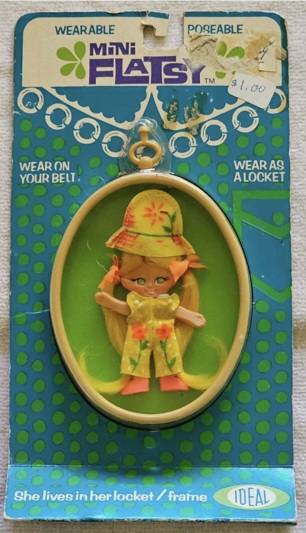 Ideal's Mini Flatsy dolls were sold in a locket