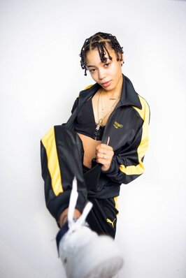 Watch the music video for "Huddy" by Coi Leray