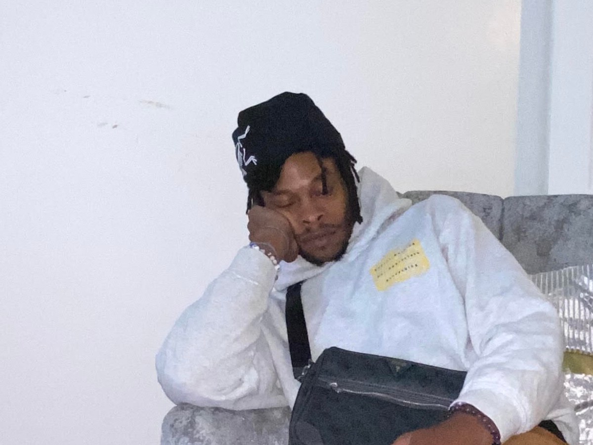 Close-up of Toronto-based artist Keeymo in a black beanie and white hoodie