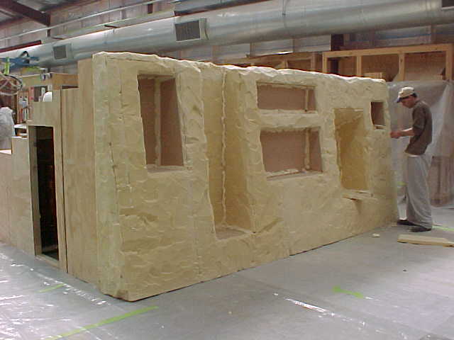 Large fibreglass trench display structure with doorway and recessed openings, ready for finishing