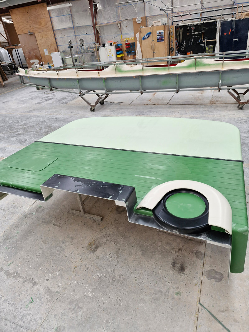 Fibreglass MRI caravan panel with painted green lower section and wheel detail