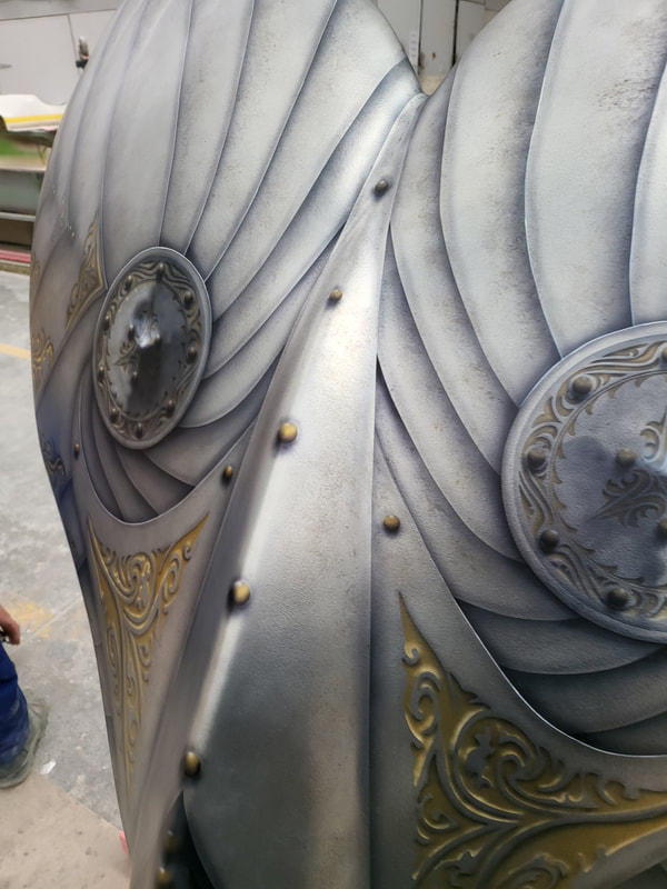 Close-up of the silver and gold detail on the “Flukes of Steel” whale-tail sculpture