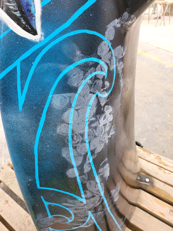 Kāpehu Whetū whale-tail sculpture during surface preparation and artwork application