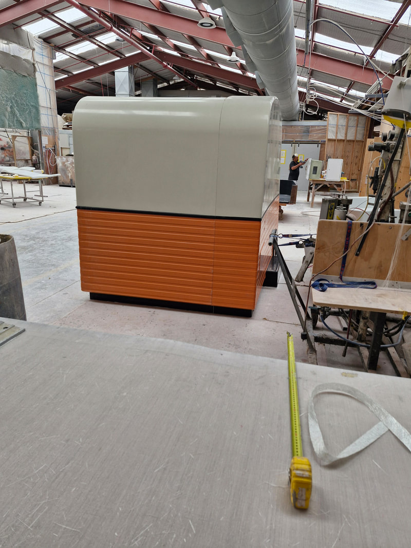 MRI caravan shell with orange lower panels during manufacture