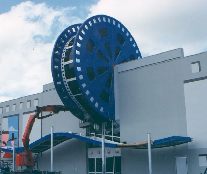 Giant blue fibreglass film reels installed on a building façade