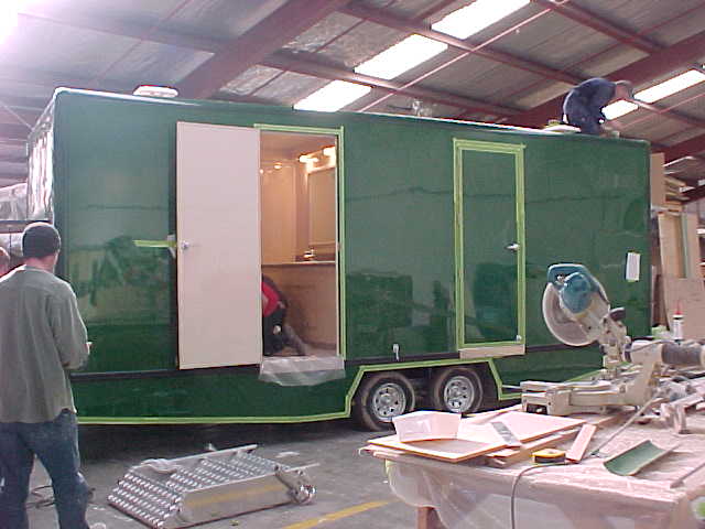 Workers completing the Super Loo exterior and roof assembly