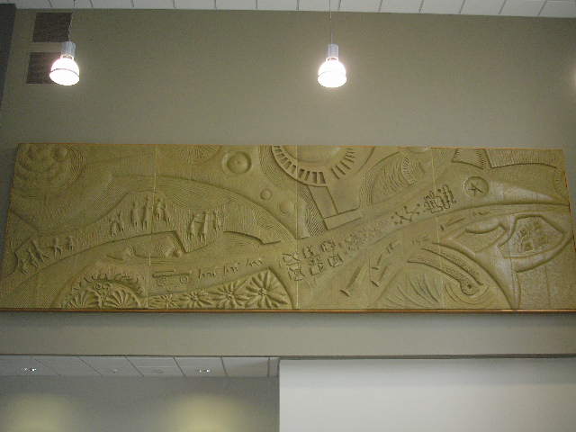 Large carved wall relief installed above an interior doorway