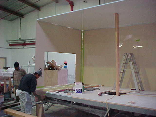 Workers assembling the Super Loo walls and roof