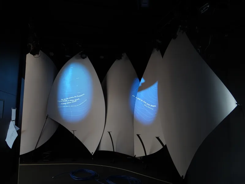 Projected displays on the completed sail forms inside the Plastic Waka
