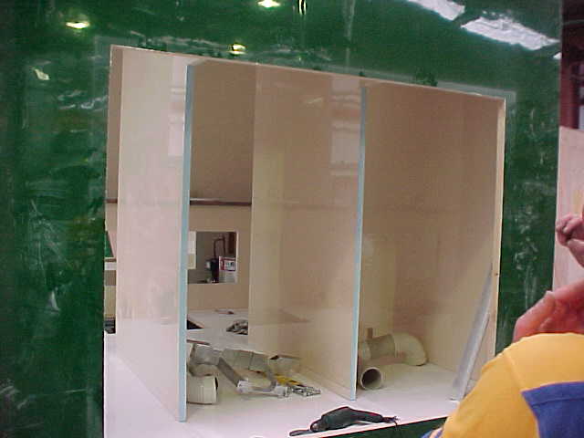 Toilet cubicle partitions being installed inside the Super Loo