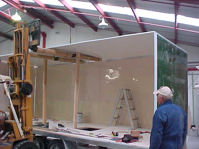 Roof panel being positioned onto the Super Loo enclosure with a forklift