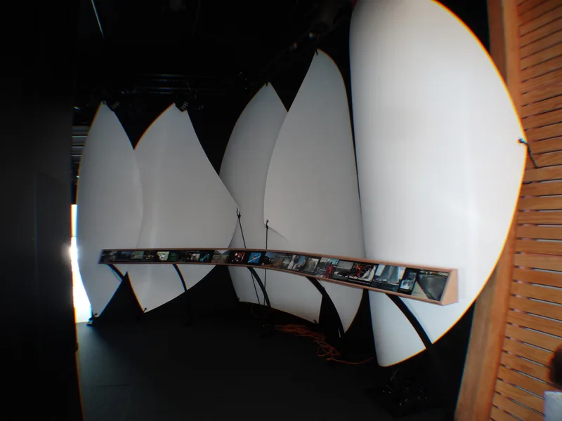 White moulded sail forms installed behind an exhibition display