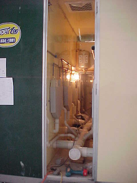 Super Loo service corridor showing installed plumbing and electrical systems
