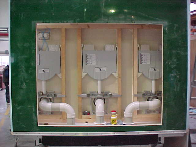 Rear service access showing the Super Loo toilet cisterns and waste plumbing
