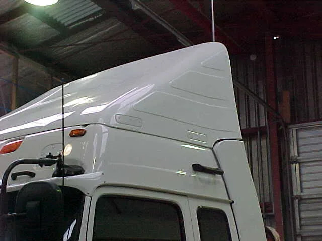 White Breeze Busta wind deflector fitted above a truck cab