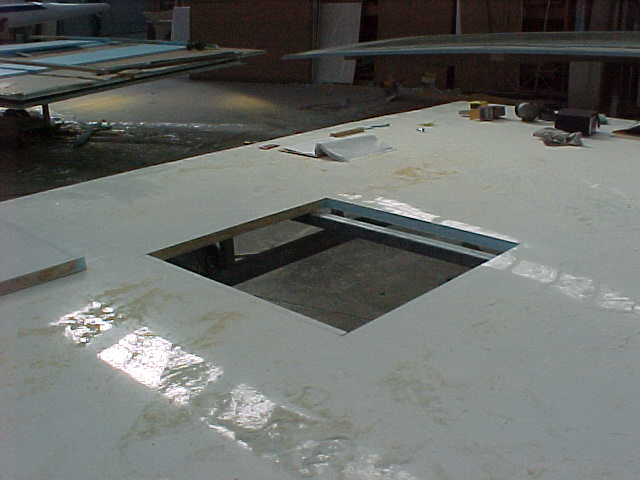 Super Loo floor panel with service openings cut into place