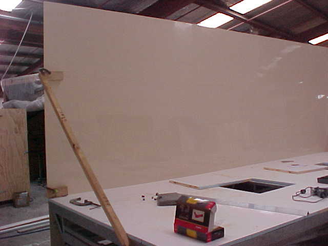 First Super Loo wall panel being positioned on the trailer base