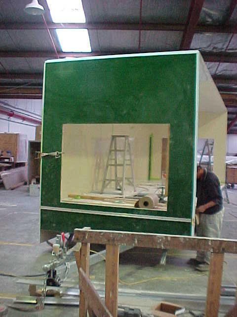 Green end wall being fitted to the Super Loo enclosure