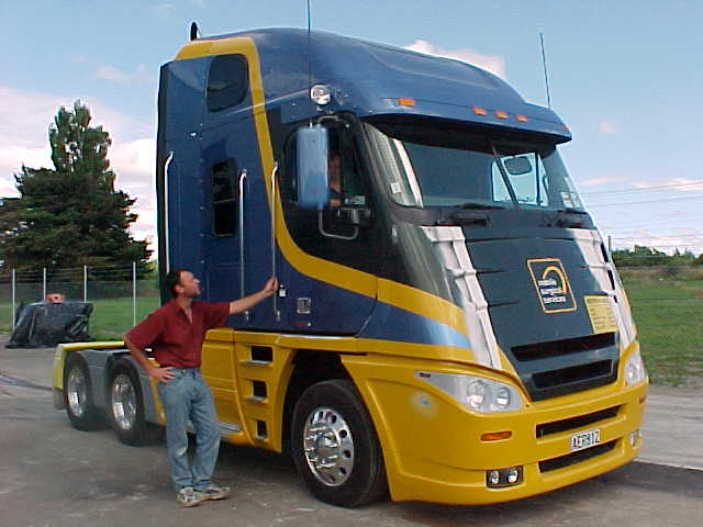Completed mobile surgery unit viewed from the front with a person standing beside it