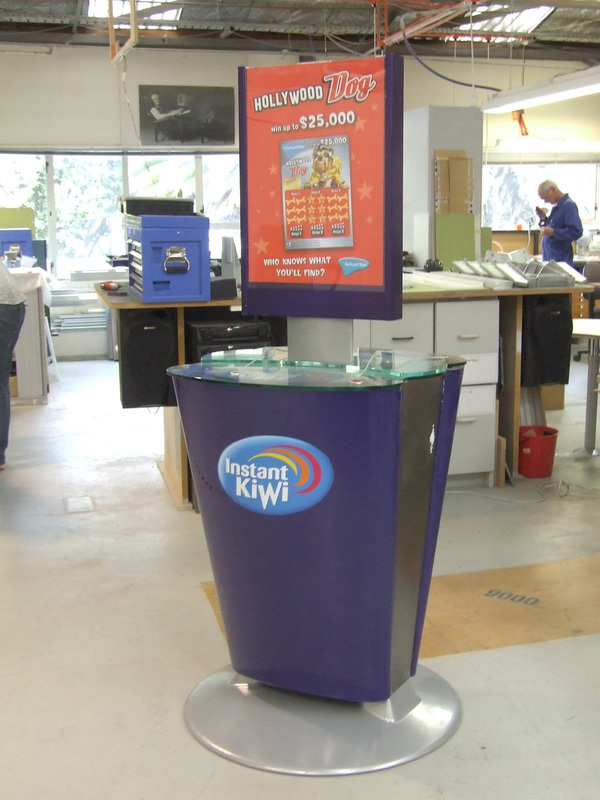Freestanding Instant Kiwi retail display stand in a supermarket