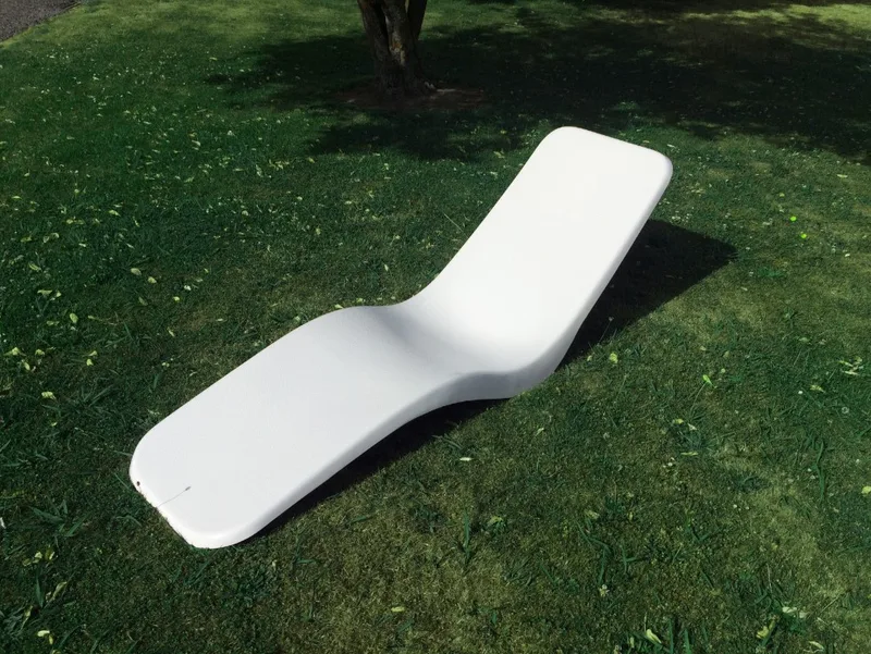White fibreglass banana sun lounger viewed from the side