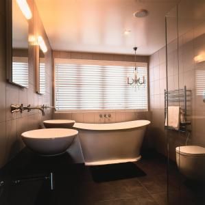Freestanding white composite bath in a modern bathroom