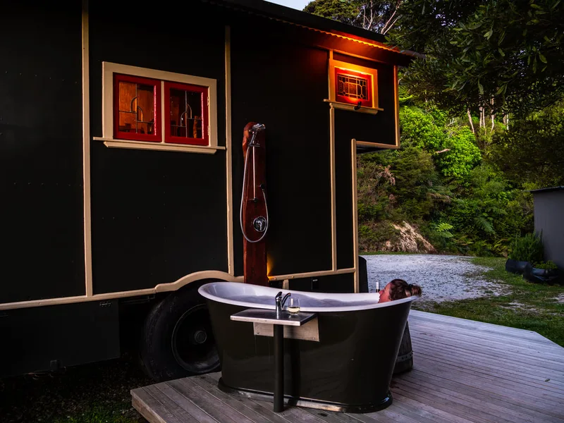 Black composite bath beside a converted house truck
