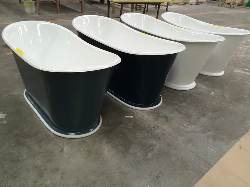 Black and white composite baths lined up in the workshop