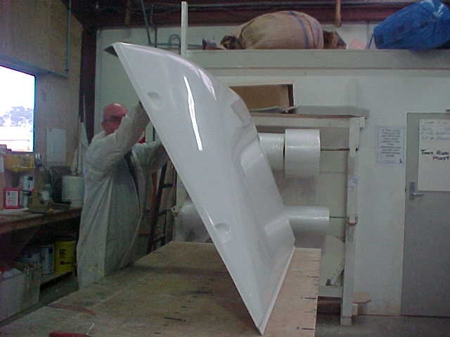 Worker inspecting a fibreglass Breeze Busta wind-deflector panel