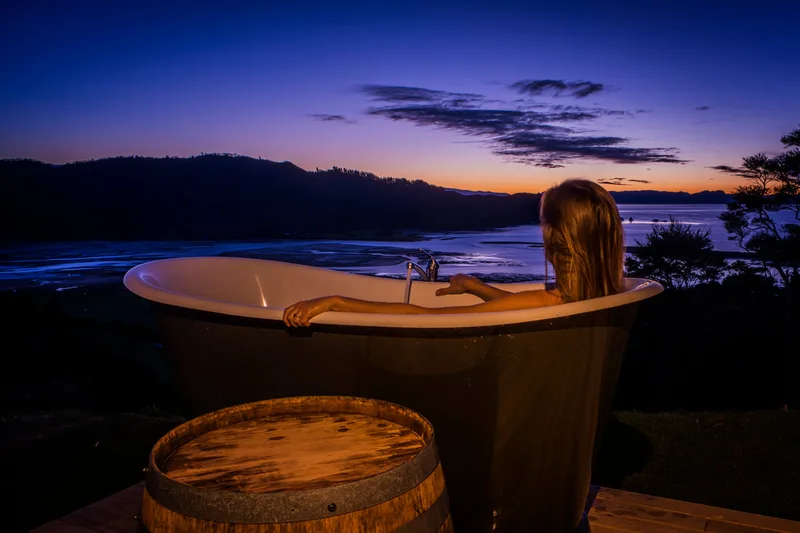 Outdoor composite bath on a deck at dusk