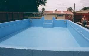 Light blue fibreglass swimming pool during installation
