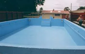 Light blue fibreglass swimming pool during installation