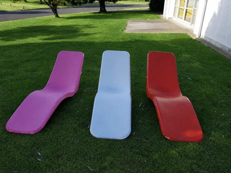 Pink, white and red fibreglass banana sun loungers
