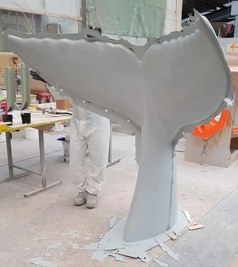 White fibreglass whale-tail sculpture after demoulding