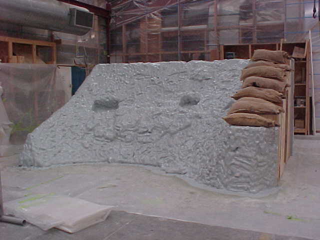 Moulded fibreglass trench wall with sandbags during manufacture