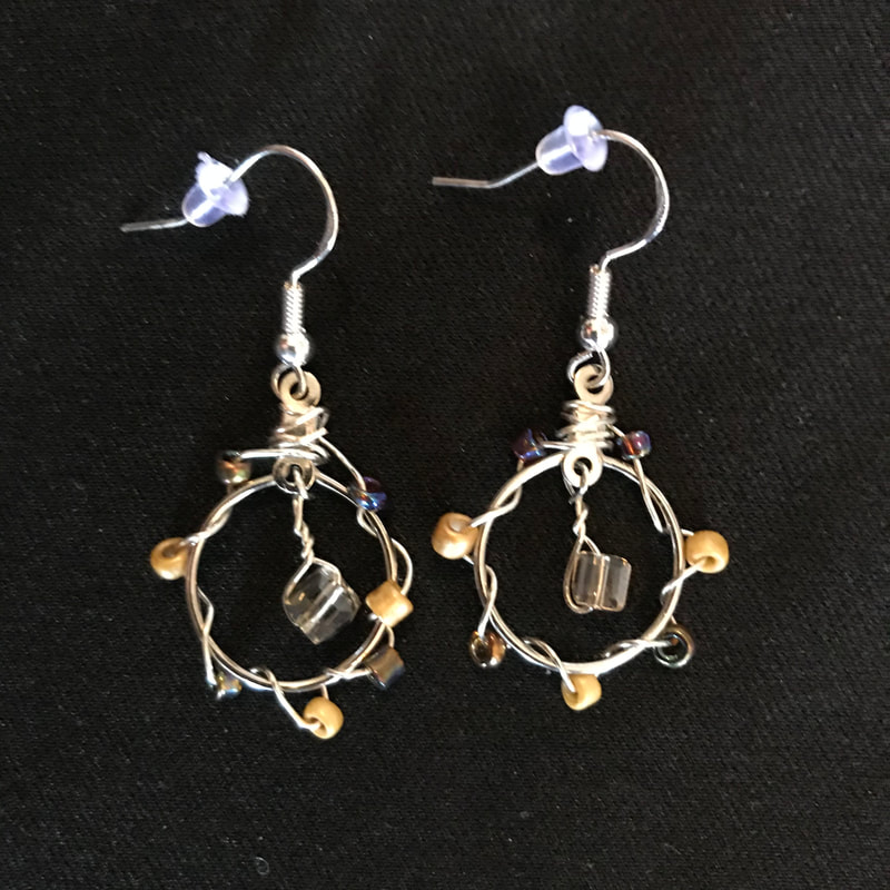 small circle earrings with yellow, brown, and gold beads
