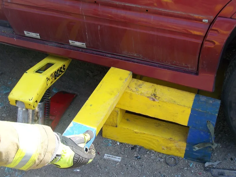Cribbing being installed as vehicle is raised by Boss tool