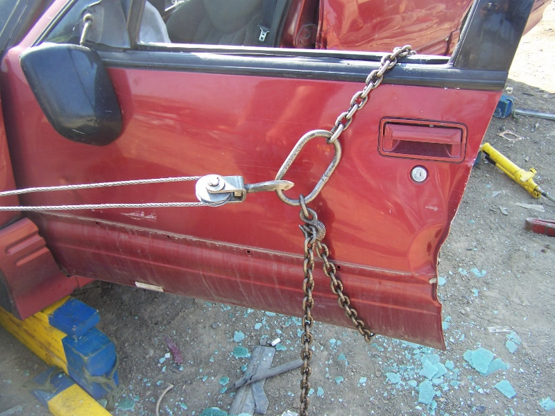 COME A LONG AND CHAIN PULLING DOOR