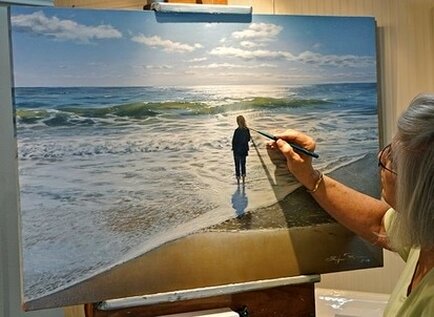 Acclaimed artist Ellen Rice is pictured putting finishing brushstrokes on her Strength of Woman Series oil 