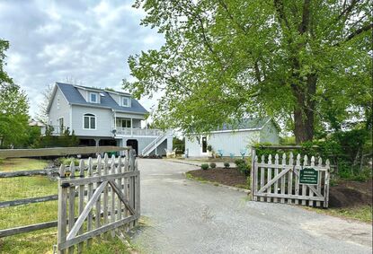 Photo of artist's home and separate studio and gallery from the driveway entrance on Territory Trail.
