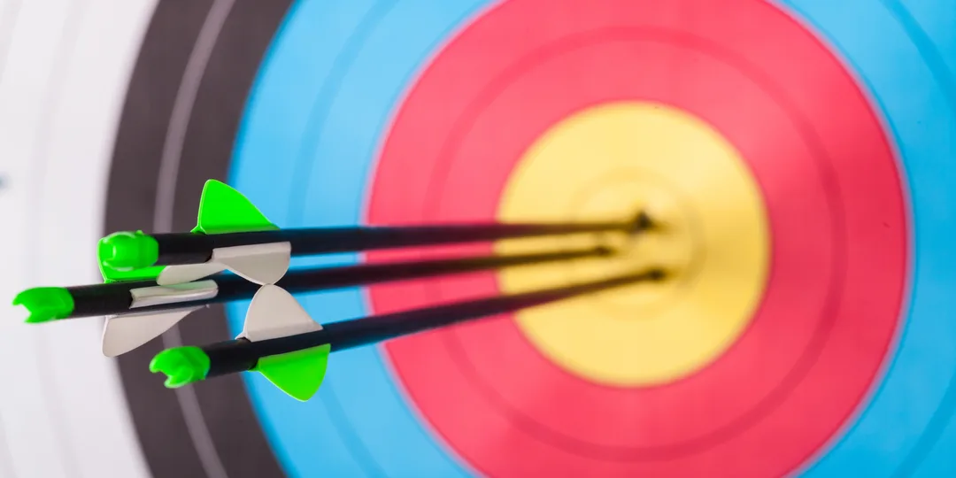 Multiple arrows shown in the center circle of a target. 