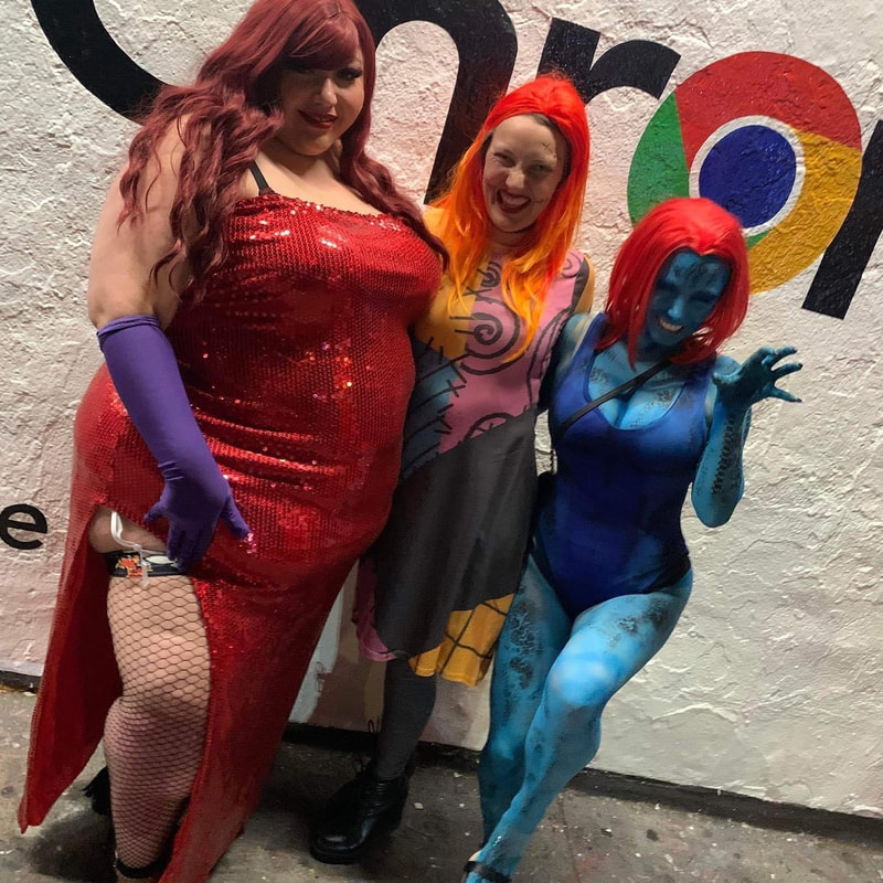 Three women at a corporate Halloween event, one dressed like Jessica Rabbit, one dressed like Sally from the Nightmare before Christmas, and one with blue body paint to be the Mystique, Oakland, Ca